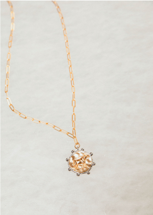 Collier chaine dorée avec pendentif signe taureau posé sur la glace bijoux MYA BAY