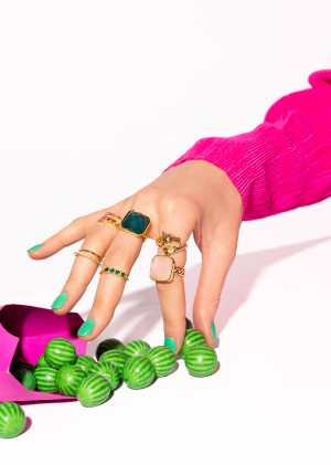 Hand with rings that takes candy MYA BAY jewels